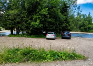 Parking przy zejściu do Chochołowskiego Potoku z samochodami w tle - Roztoki, Witów